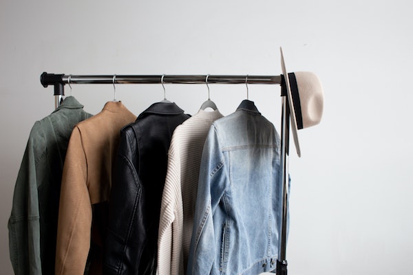 Clothes and a hat on a rack