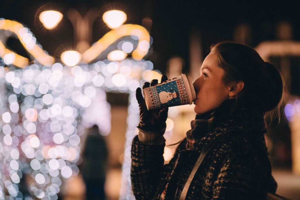 A lady sipping coffee in winter